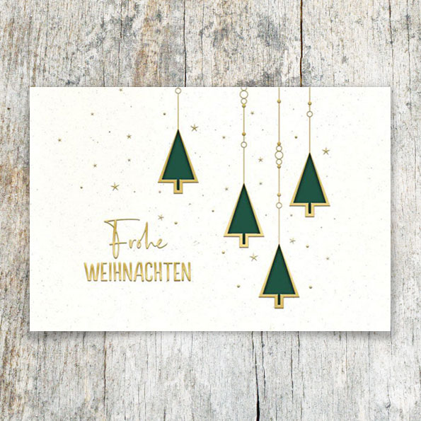 Weiße Weihnachtskarten mit goldenen Prägungen und Formstanzungen.