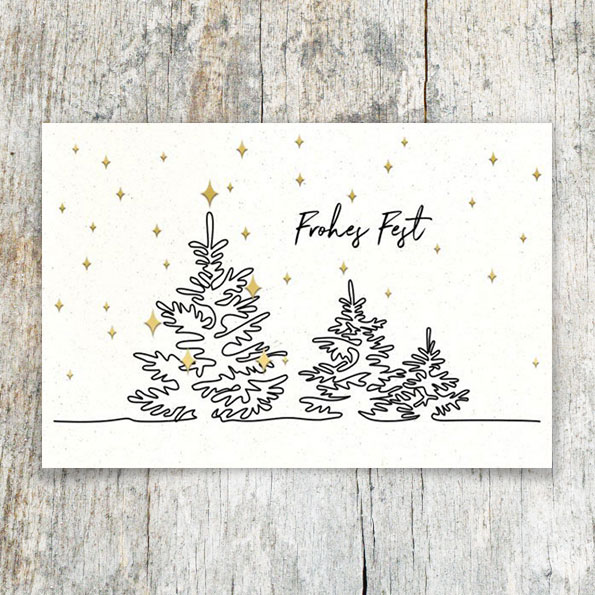 Weiße Weihnachtskarten mit schwarzen und goldenen Folienprägungen.